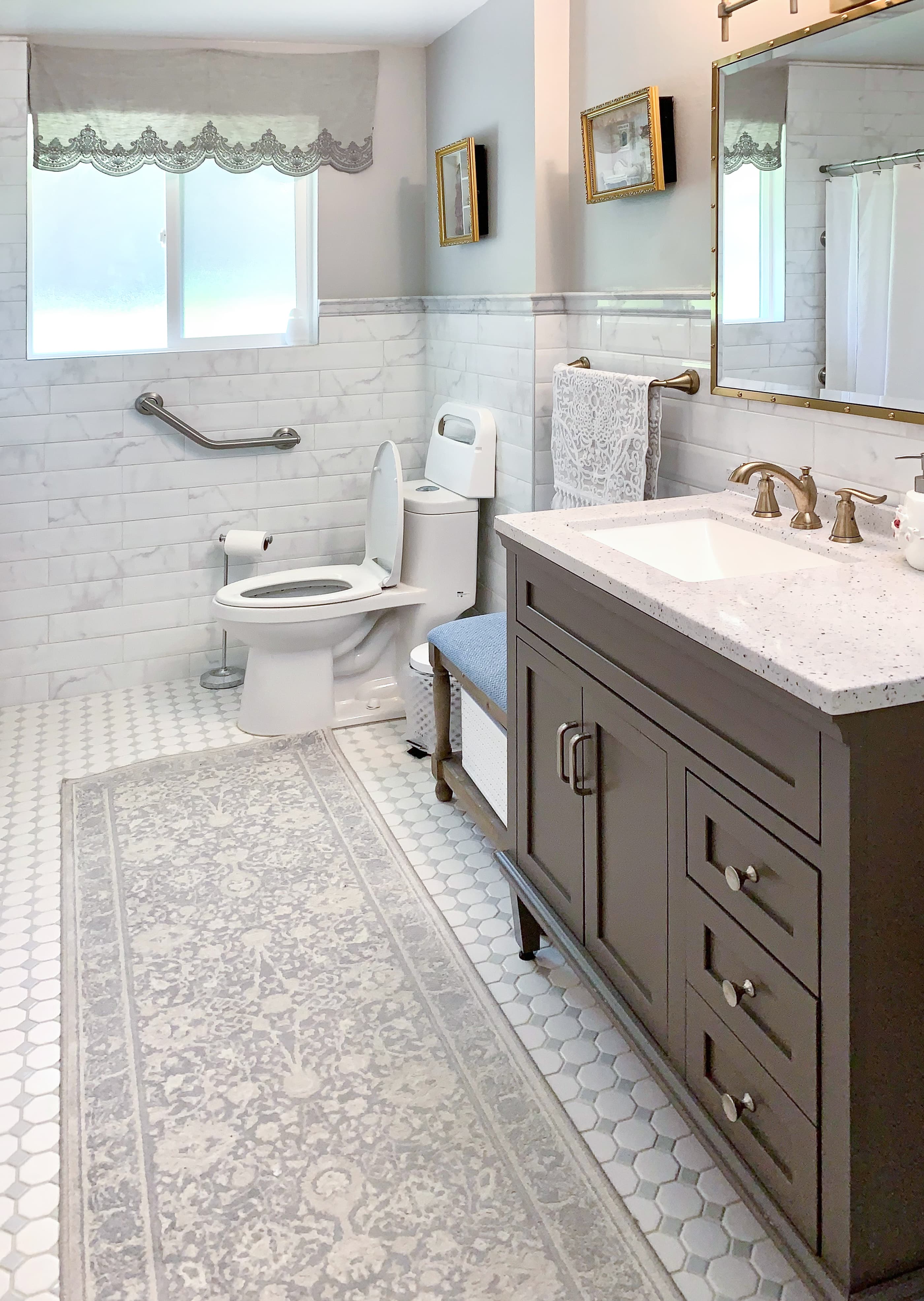 A Brookwood House bathroom vanity with neutral counters and a framed mirror.