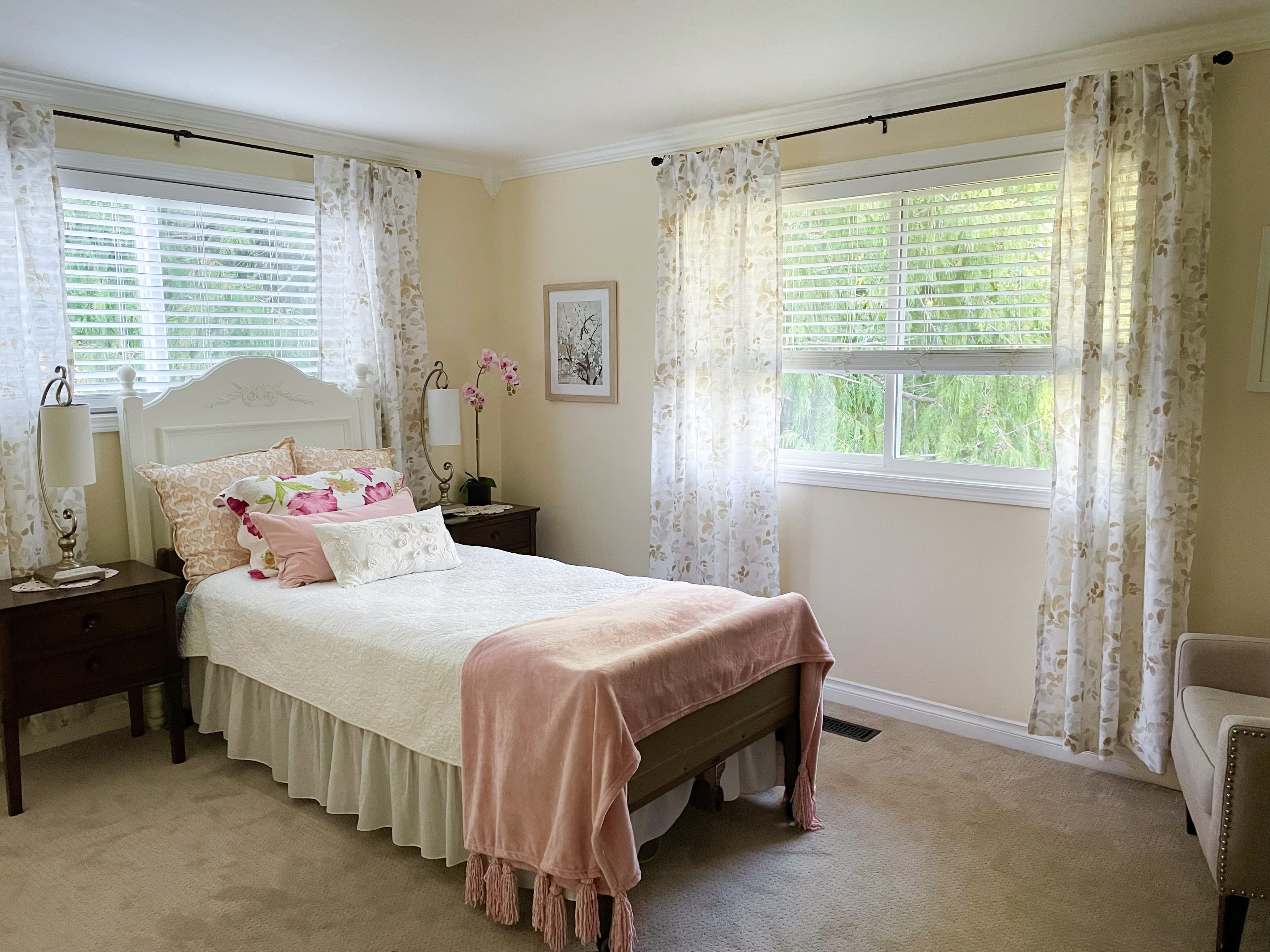A Brookwood House bedroom with soft linens and large windows.