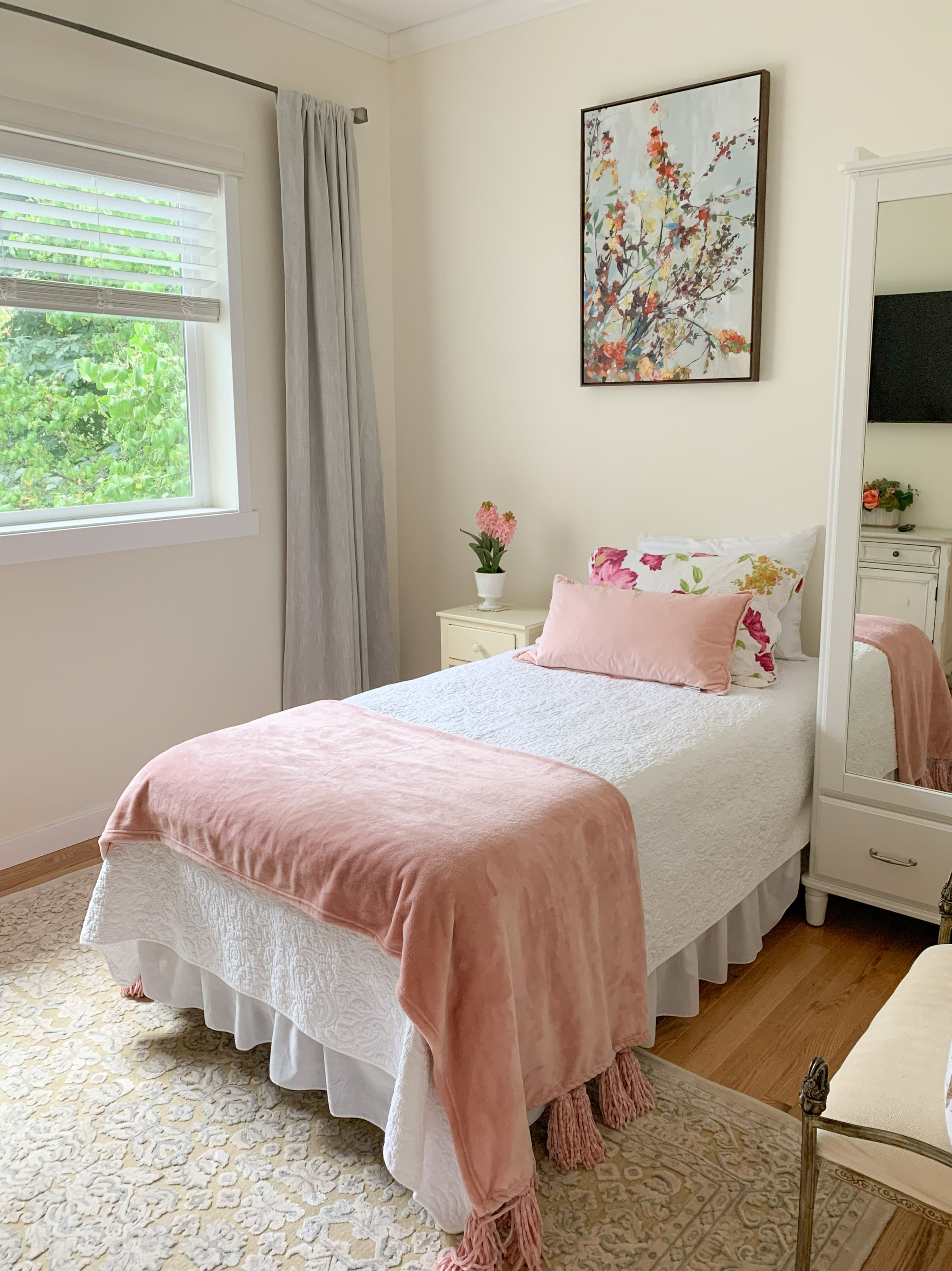 A Brookwood House bedroom with natural light and minimal furniture.
