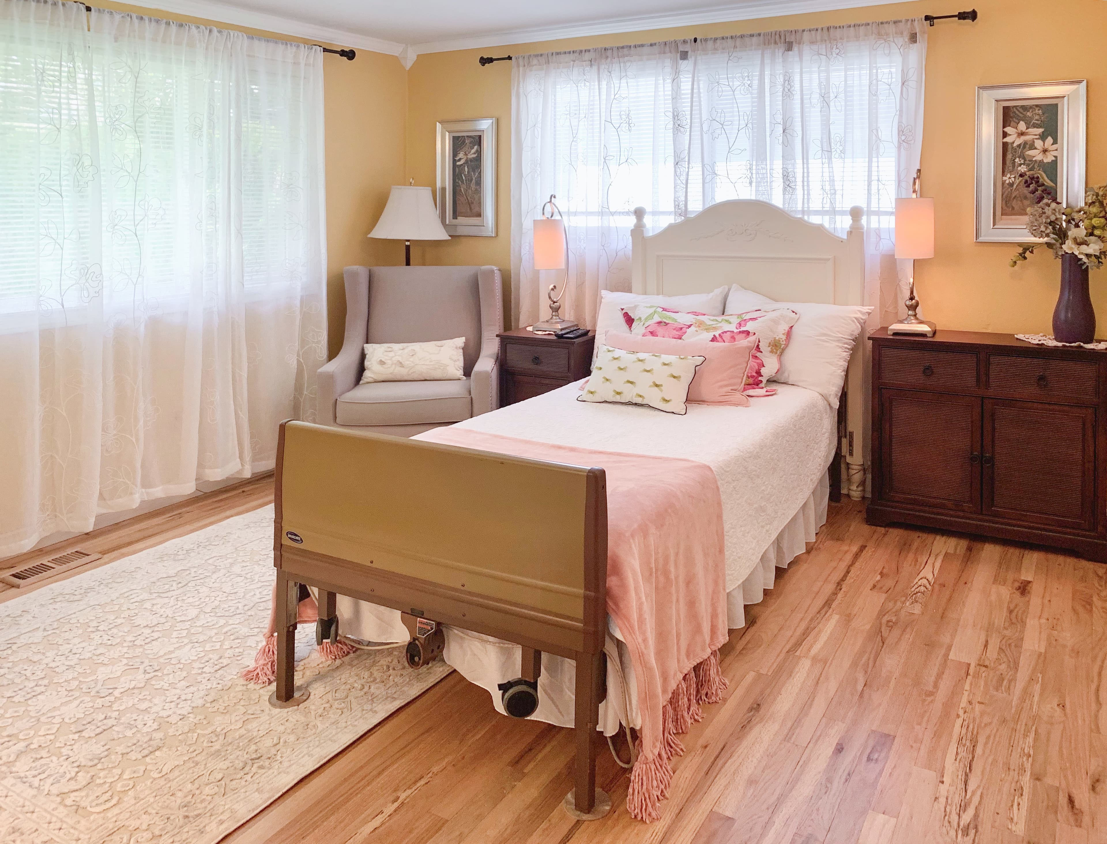A bedroom at Brookwood House with crisp linens and soft daylight from the window.