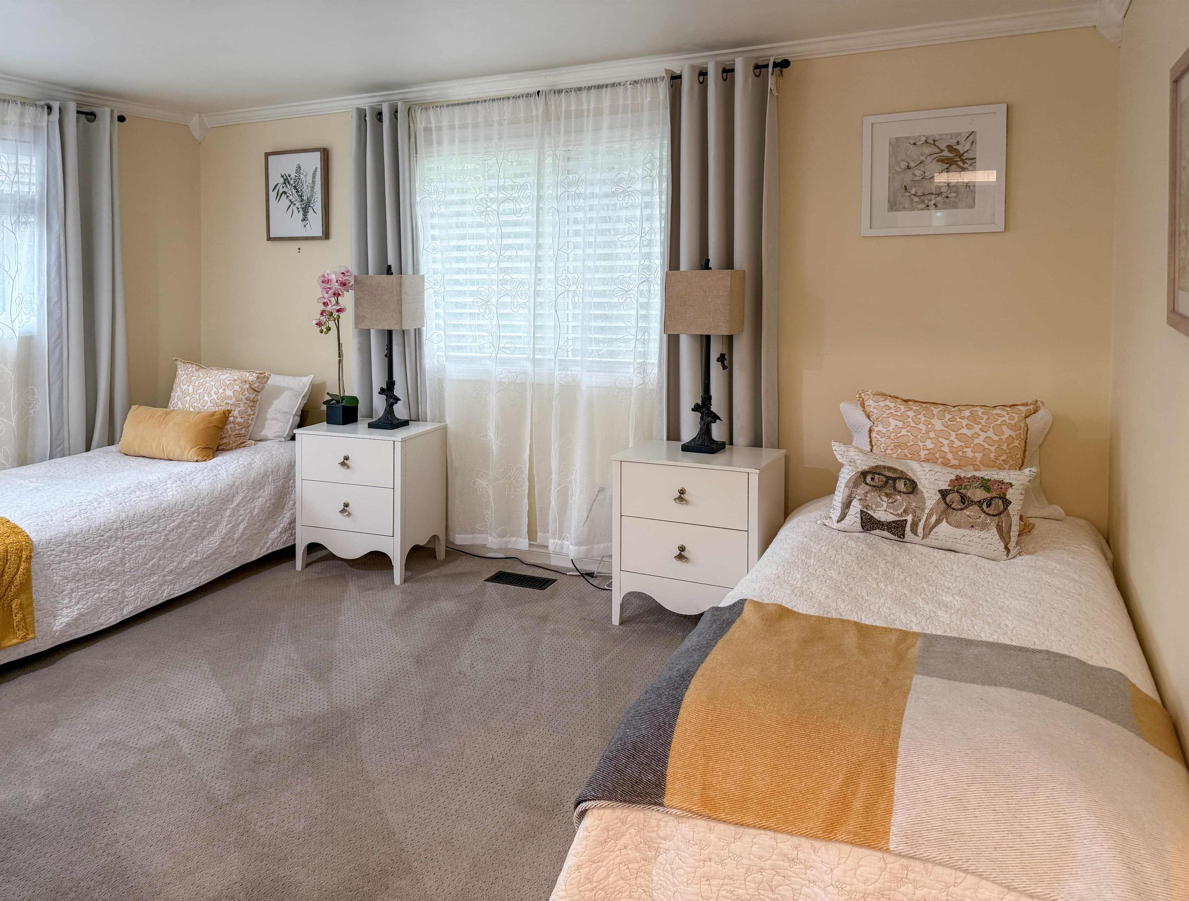 A Brookwood House bedroom with calm tones and a window-side view.