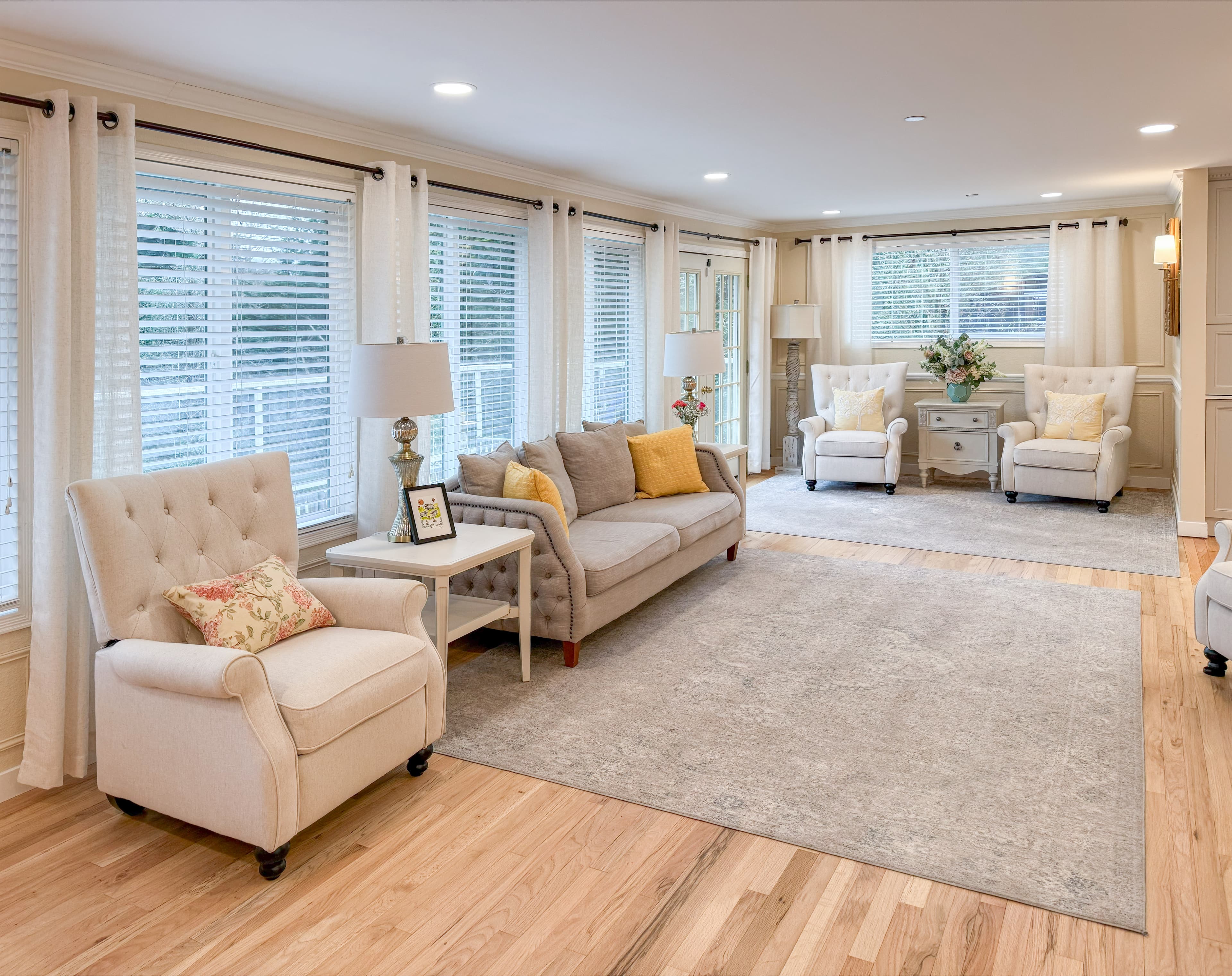 The living room at Brookwood House, with soft seating, wood floors, and natural light.