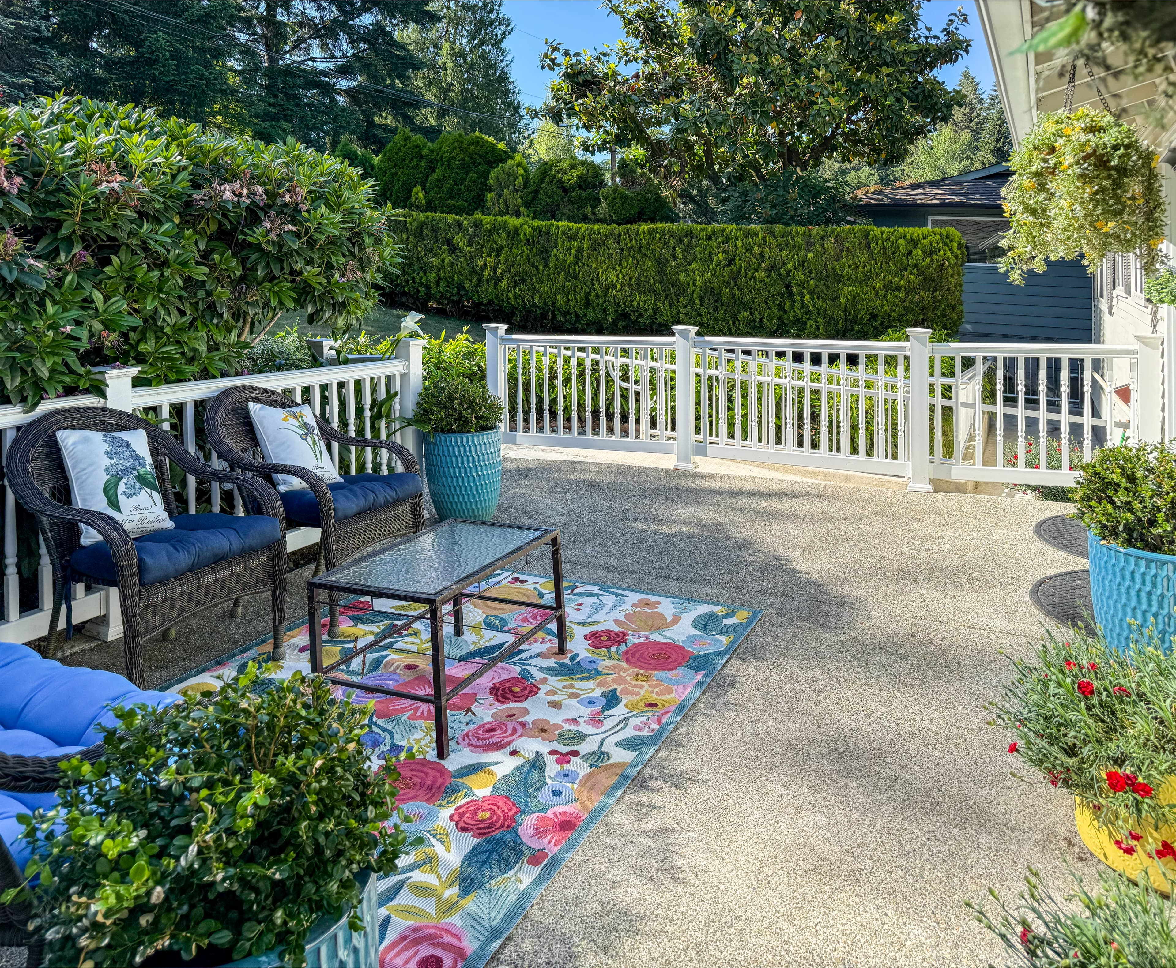 The garden and patio at Brookwood House, surrounded by lawn and mature trees.