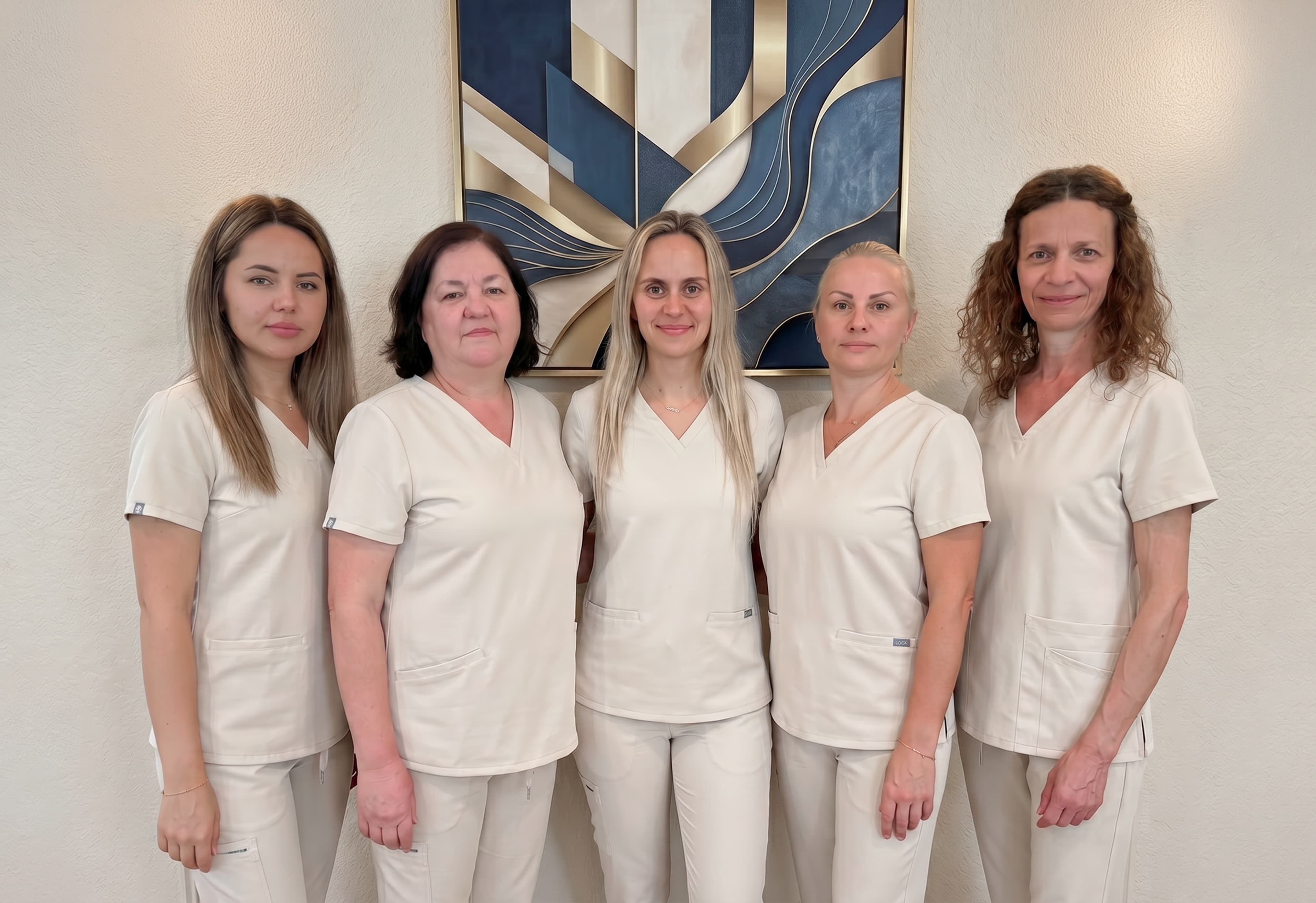 The Brookwood House care team, five caregivers in cream uniforms standing together.